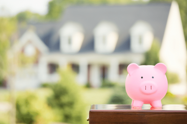 piggy bank in sunny climate sits outside front of house